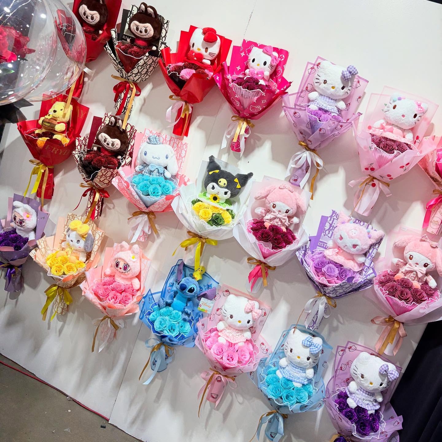 Colorful character-themed rose bouquets with plush toys displayed at The Hidden Gift Store