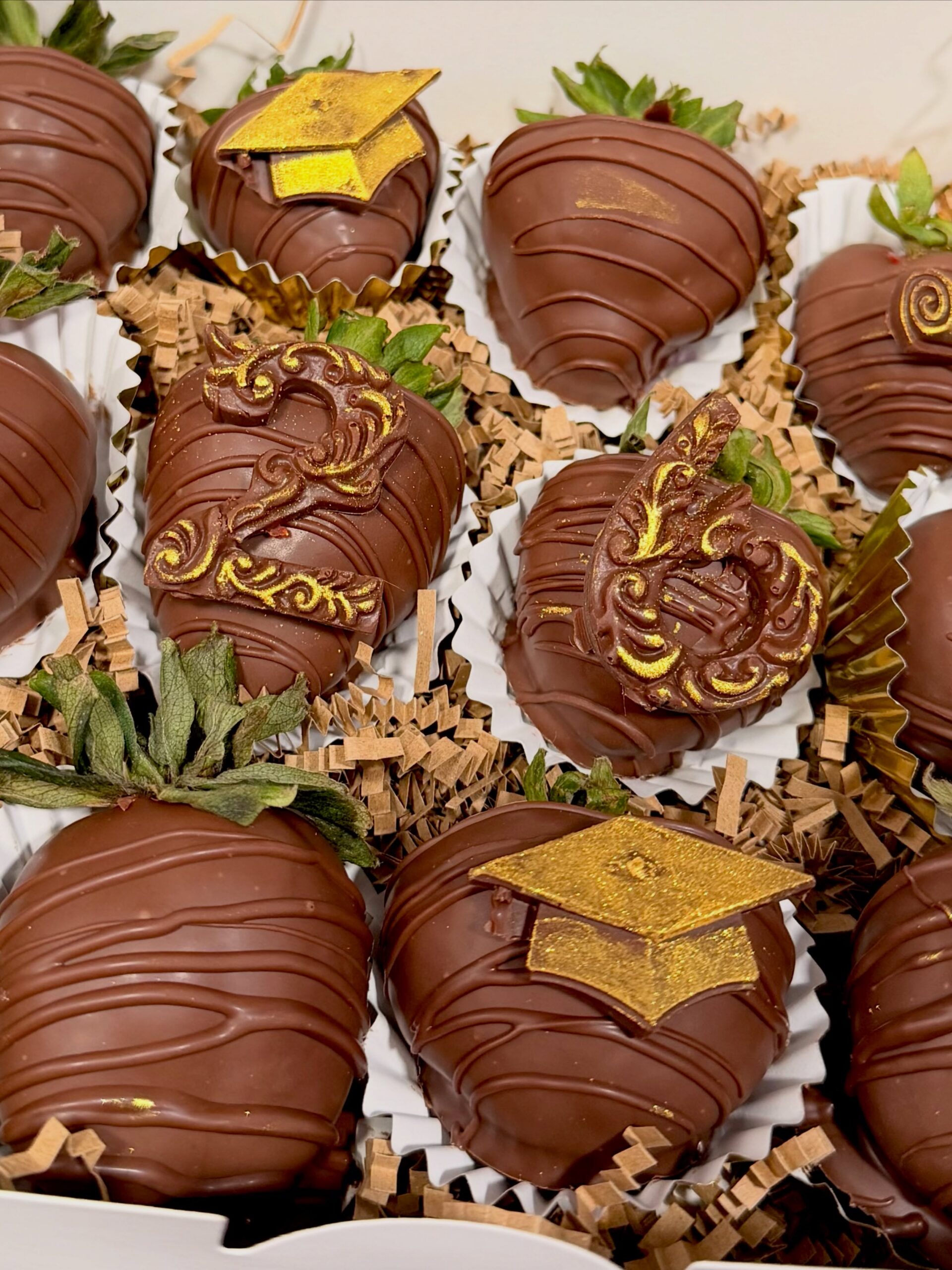 Chocolate-covered strawberries decorated with gold graduation caps and elegant chocolate designs from The Hidden Gift Store