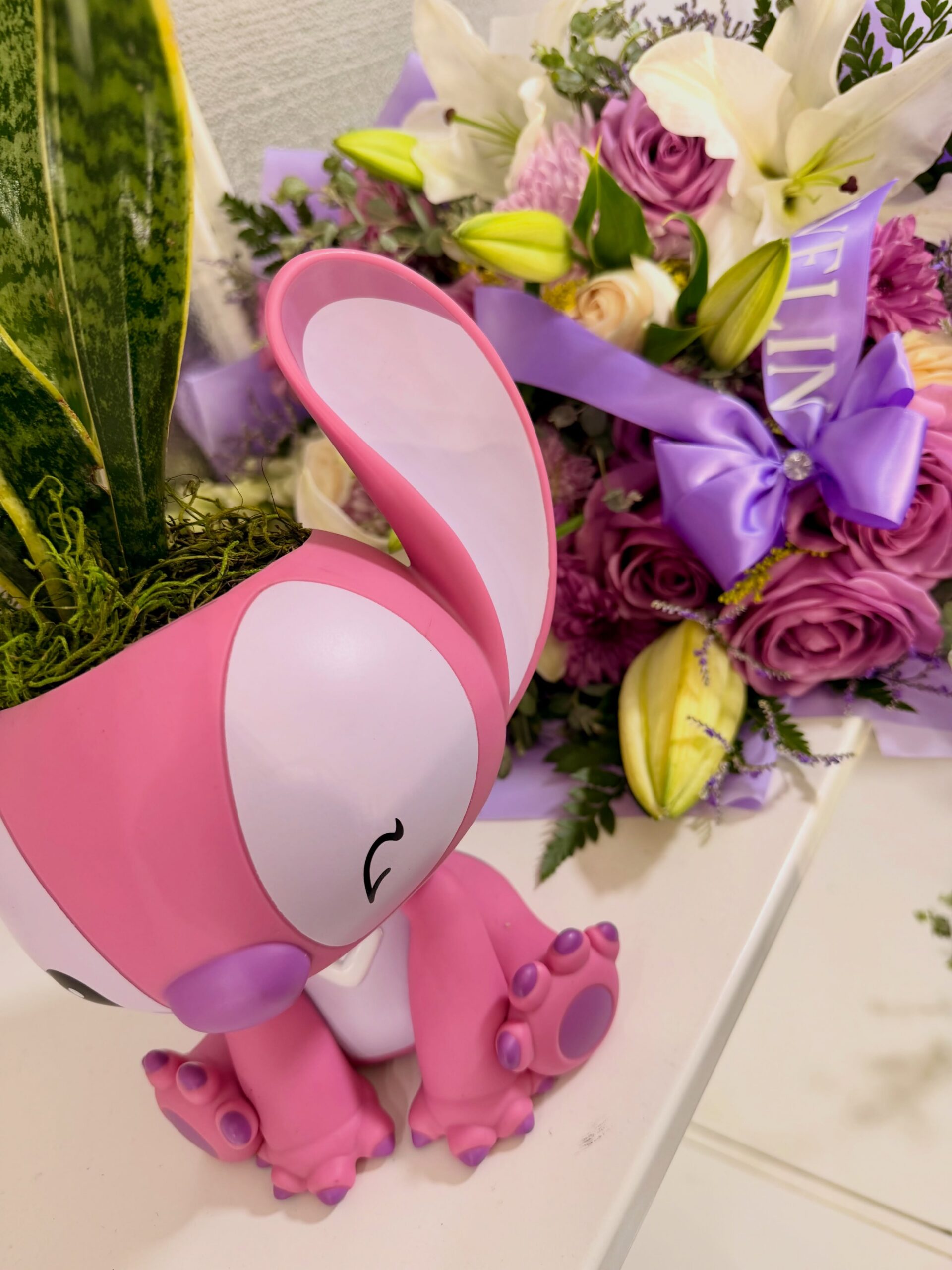 Pink Stitch-themed gift with purple rose and white lily flower bouquet